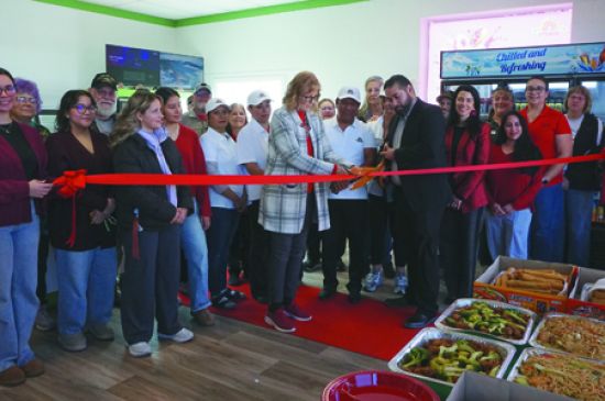 Crispy Ring cuts ribbon on donut shop